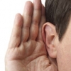 Man cupping his ear