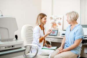 older woman taking with her eye doctor