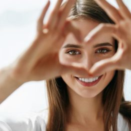Woman holding fingers in a heart shape