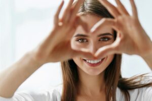 Woman holding fingers in a heart shape