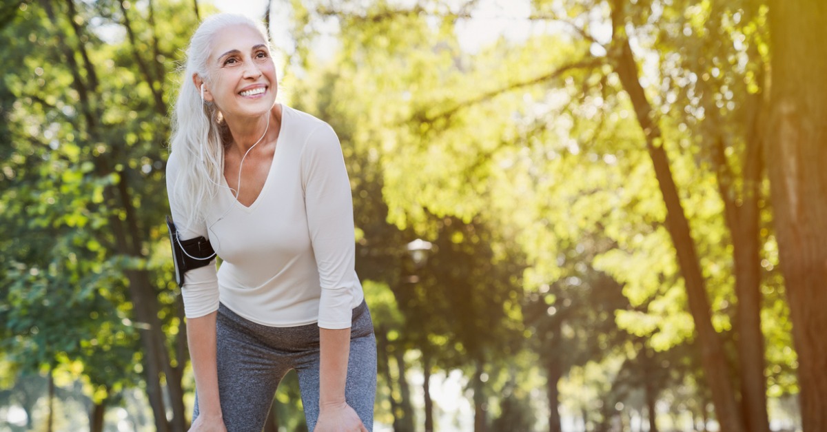 Mature woman resting after jogging outdoors