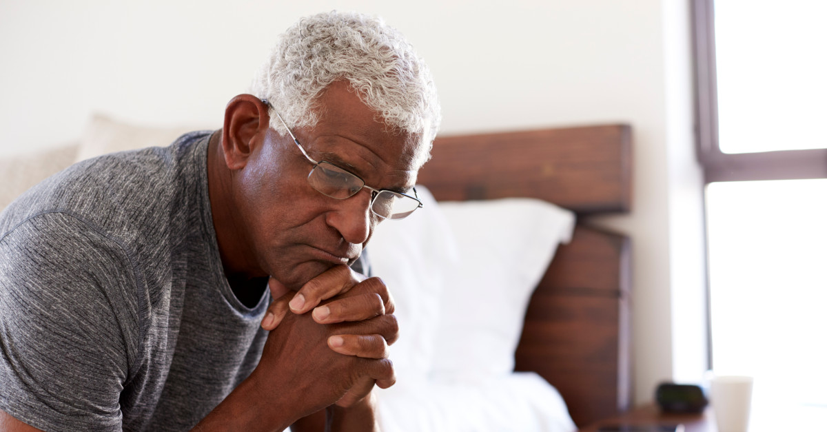 Black man holding hands in deep thought