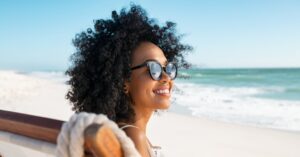 Beautiful woman with sunglasses on at beach