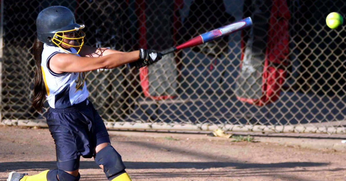 Hitting ball with baseball bat