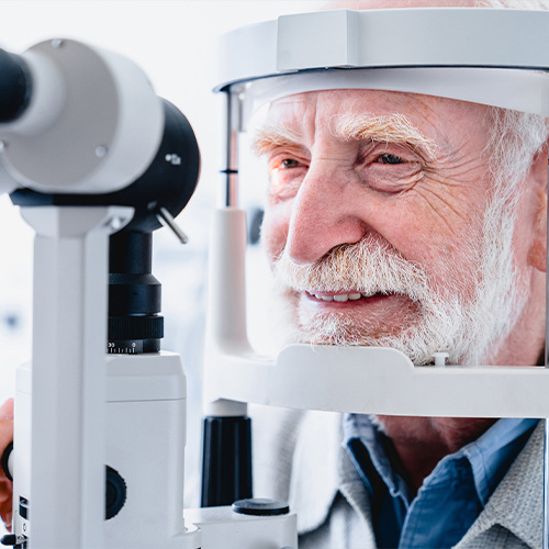 A senior citizen receiving an eye exam for cataracts.