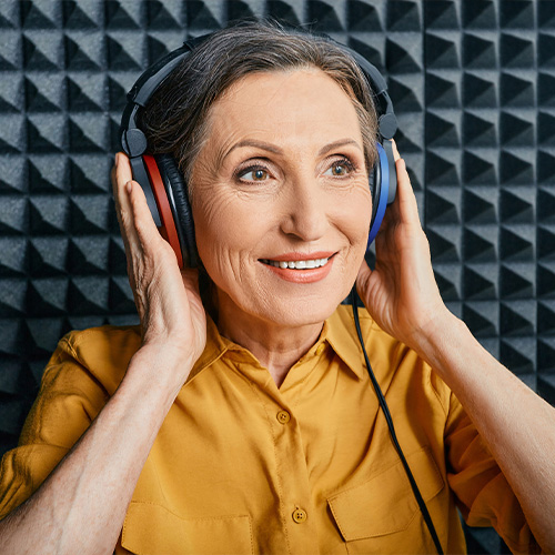 A senior woman doing a hearing test with headphones on.