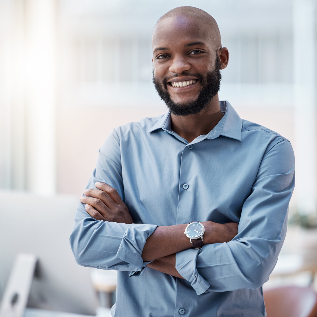 Cropped portrait of a handsome young businessman standing with his arms crossed in the office