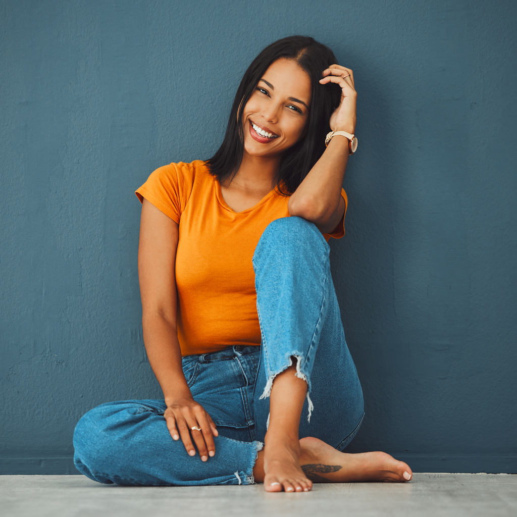 Woman smiling sitting on the floor