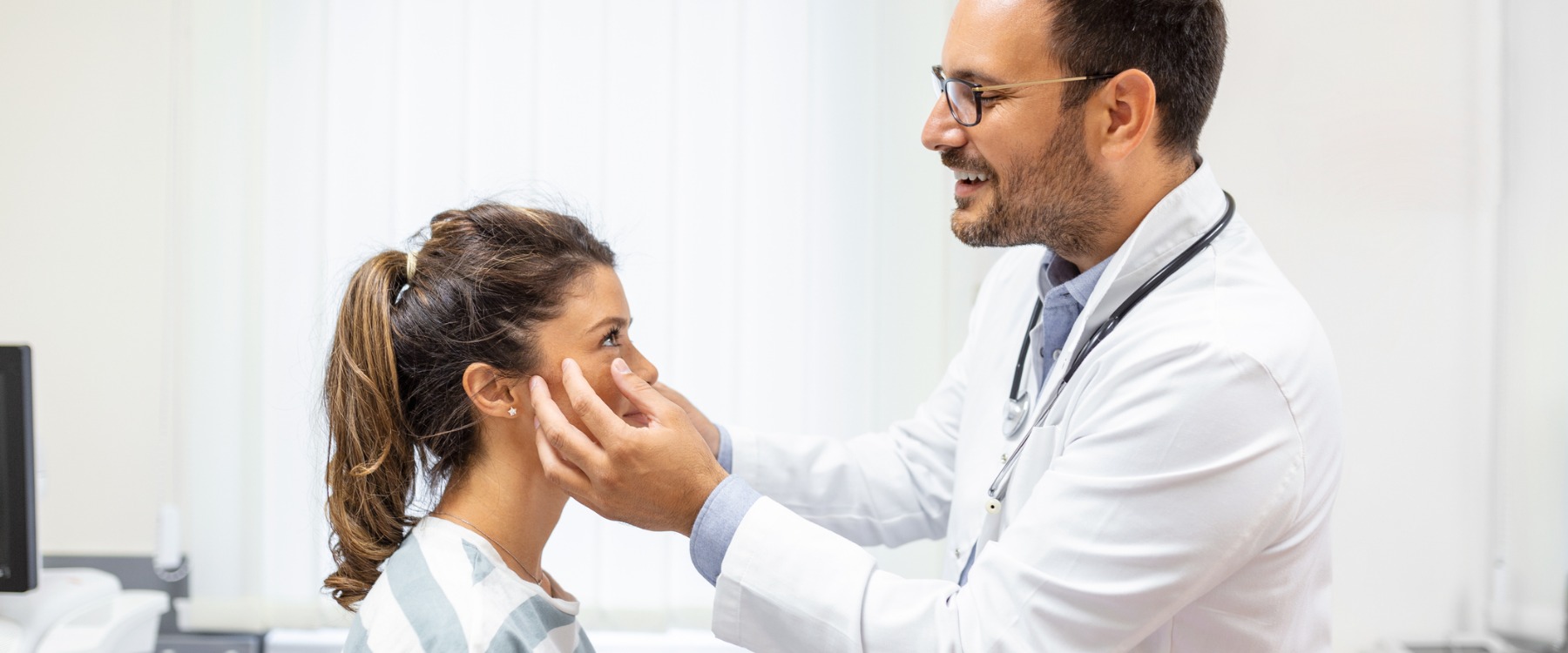 eye doctor examining woman's eyes