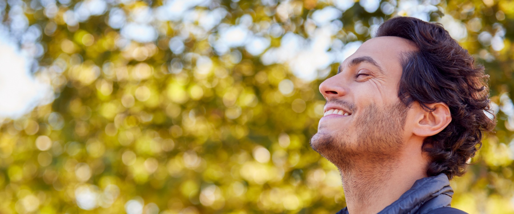 Calm man smiling outside