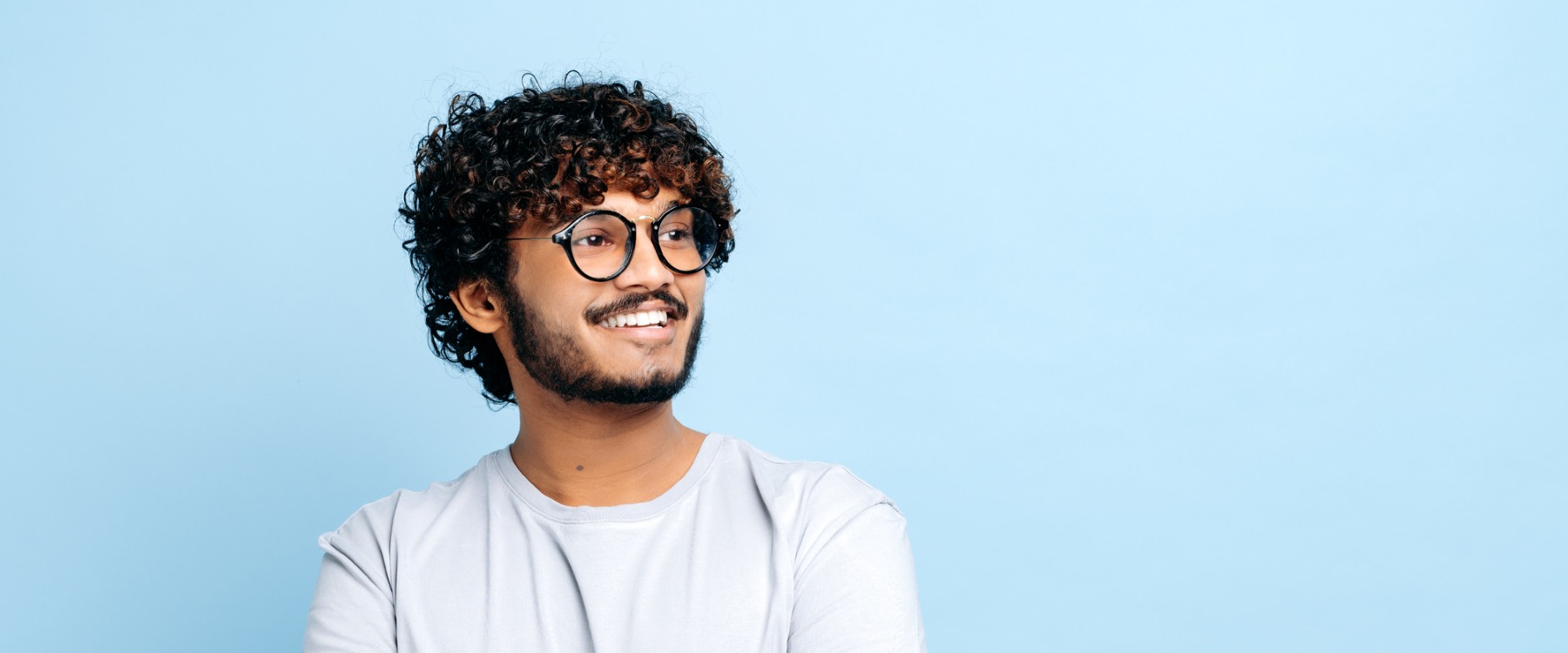 Guy with curly hair smiling