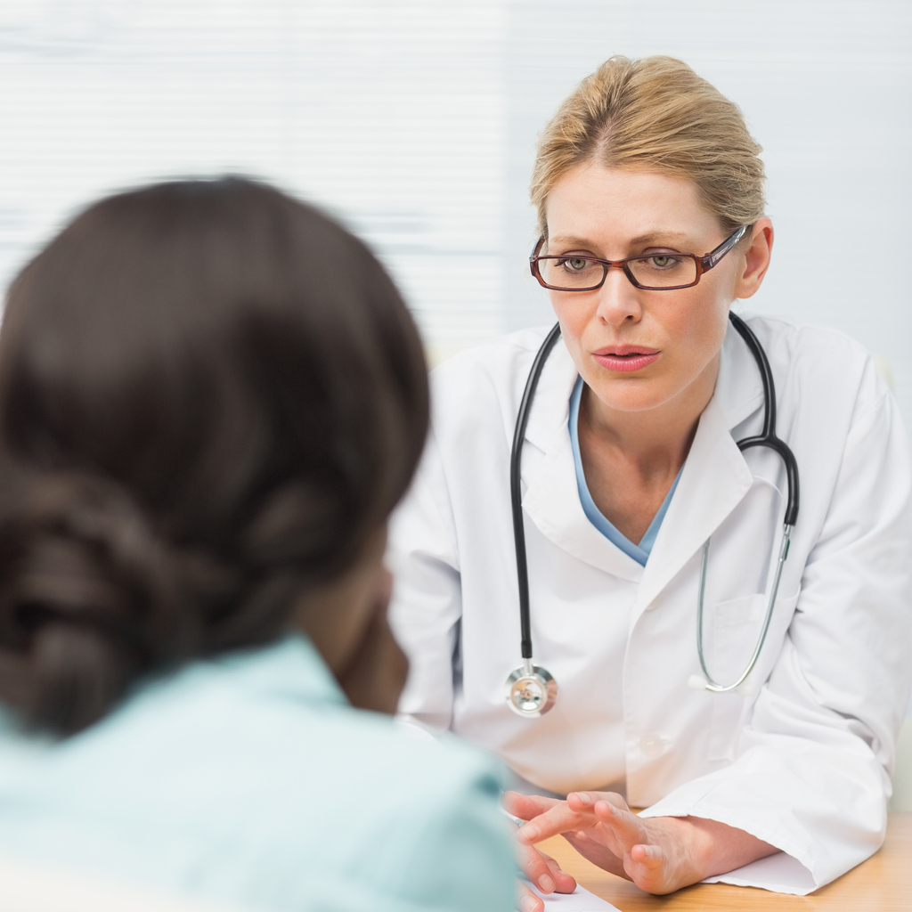 Concerned doctor talking to her patient