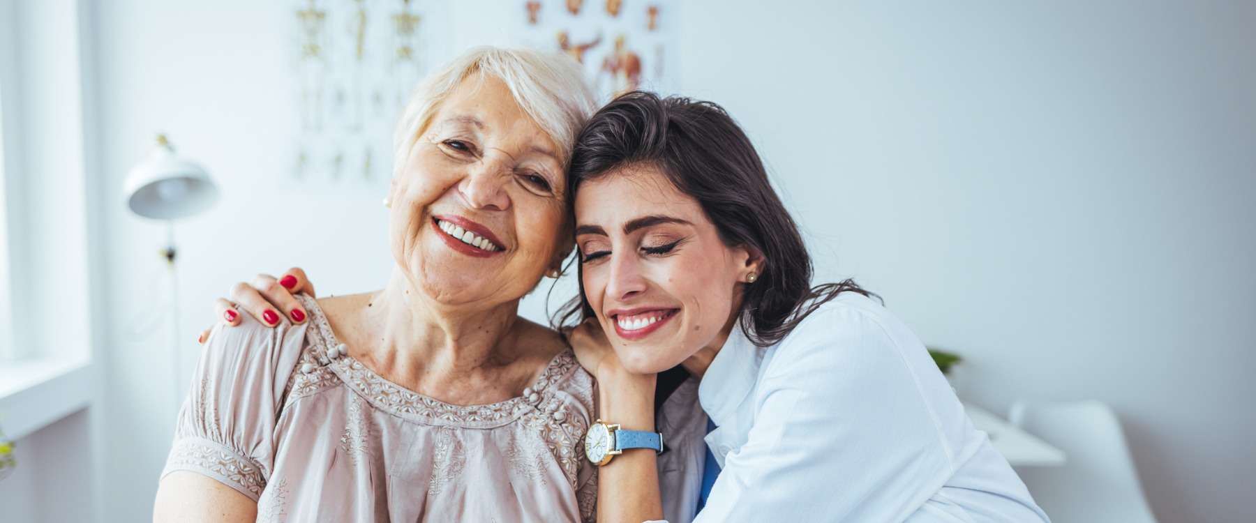 elderly woman hugging doctor