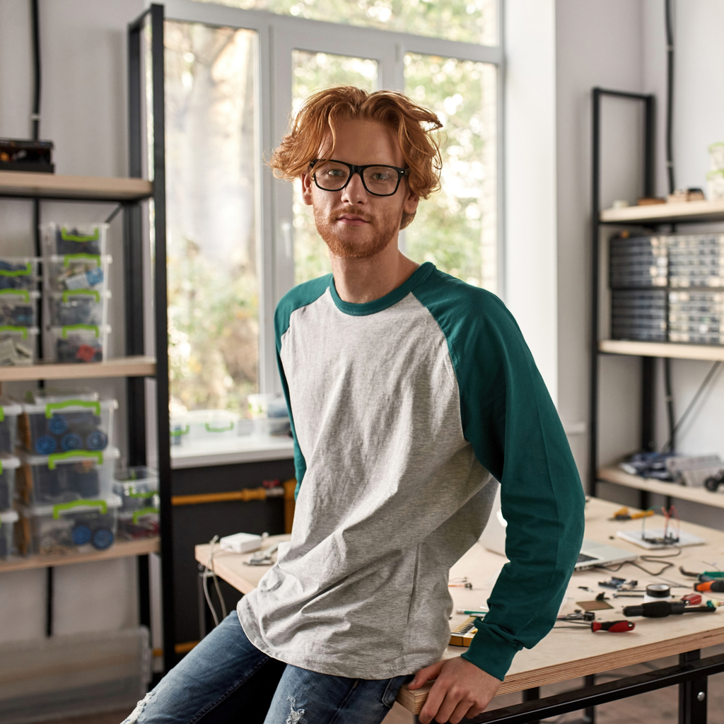 guy with glasses sitting on table