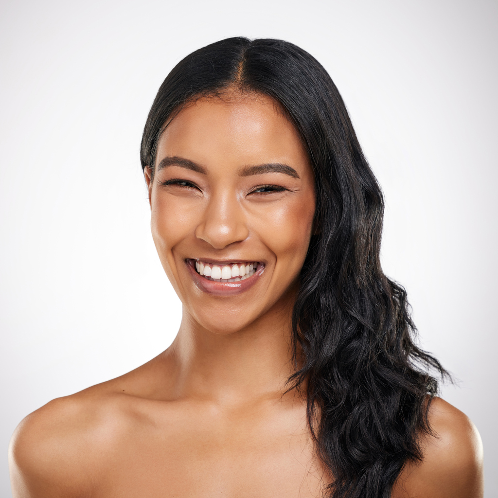 Shot of a beautiful young woman posing against a grey background