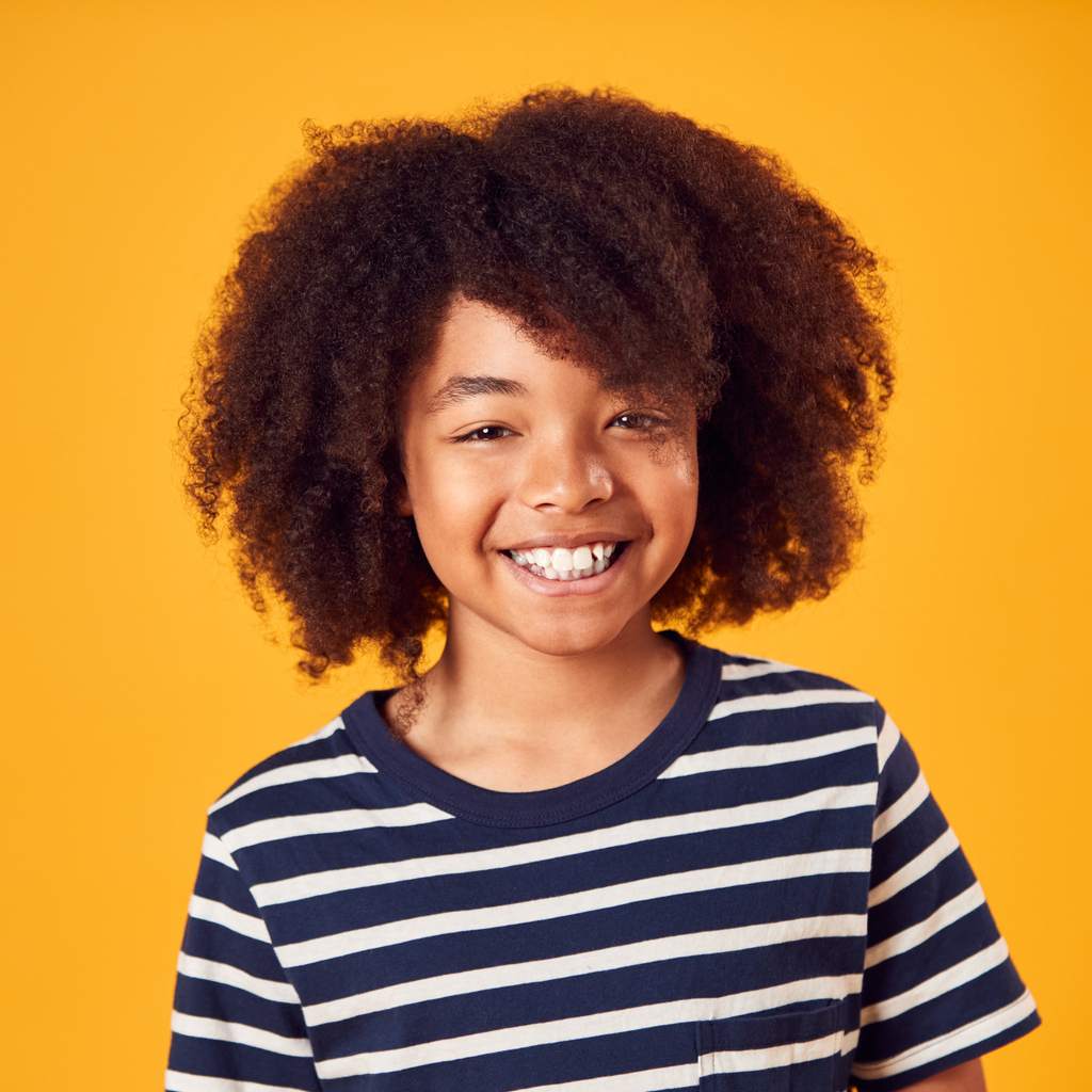 Happy kid smiling orange background