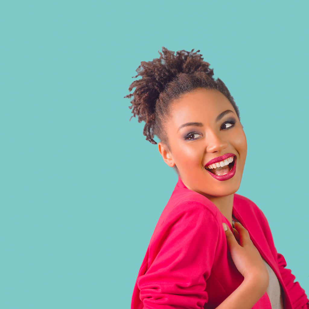 portrait of beautiful attractive cheerful smiling young woman (mixed race) in pink blazer