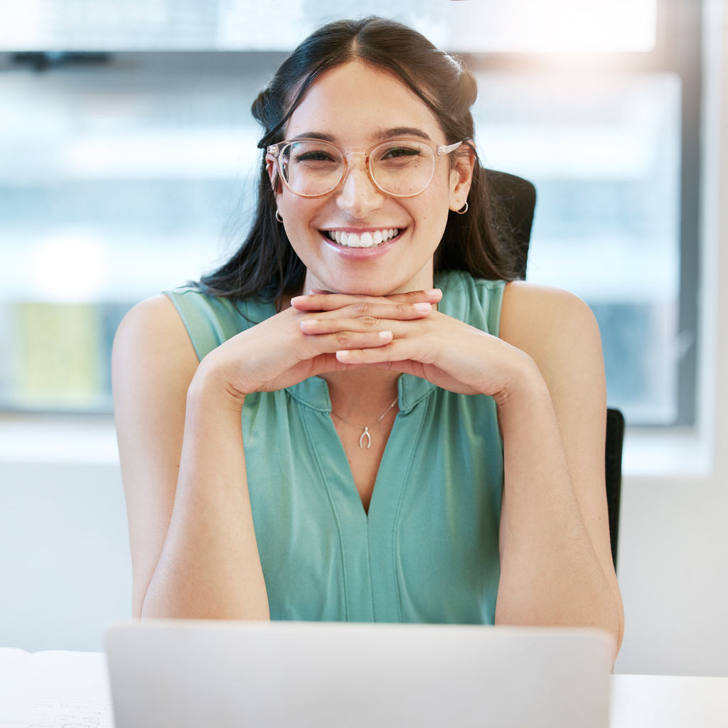 Confident young woman at work smiling