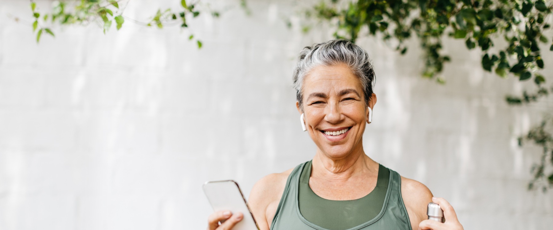 Happy senior woman with phone in hand