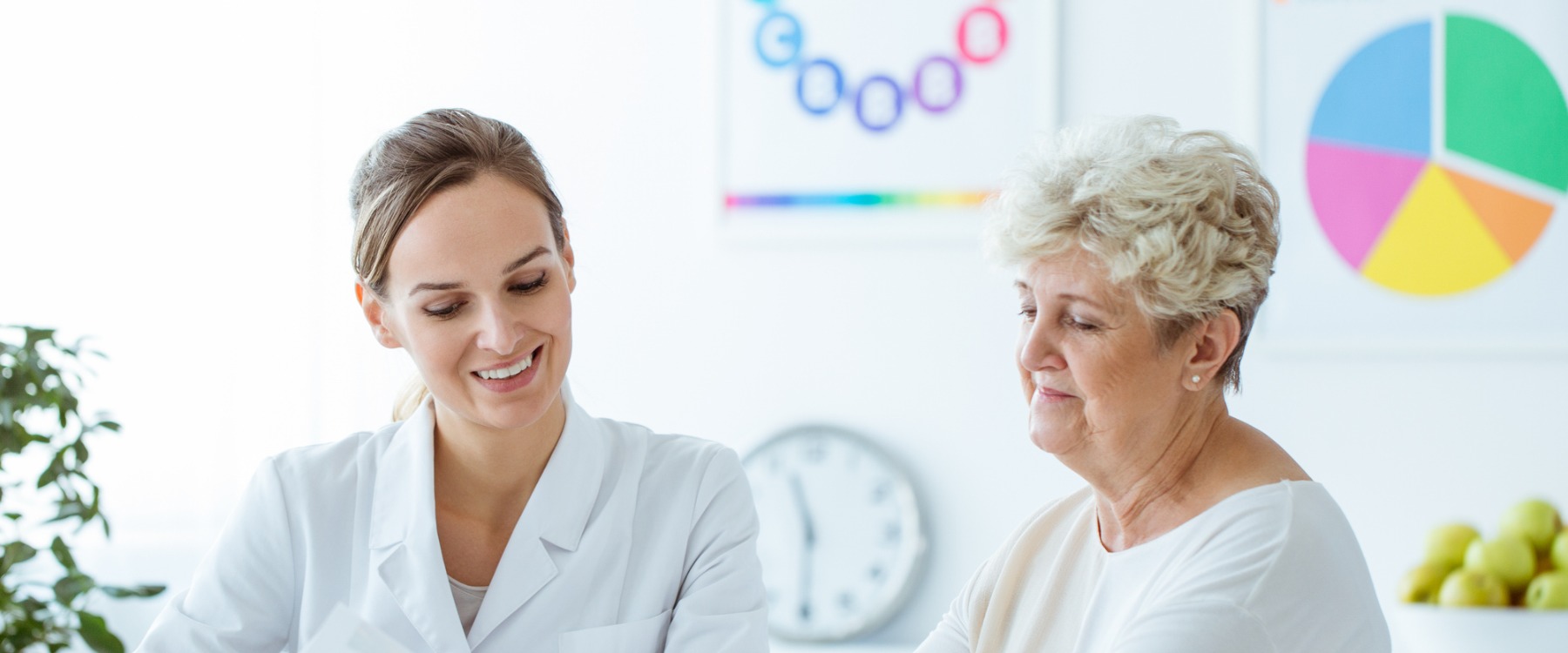 Smiling doctor showing client a plan