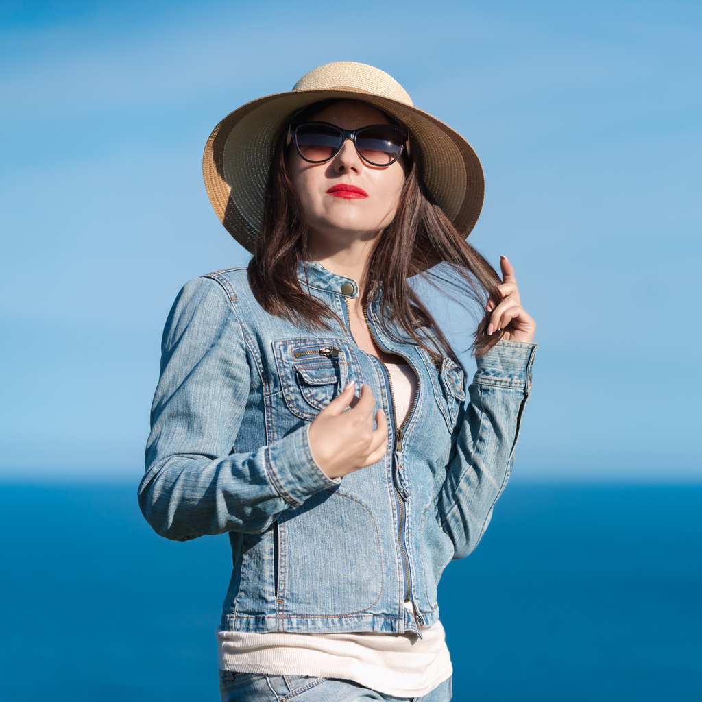 Woman in sunglasses and hat