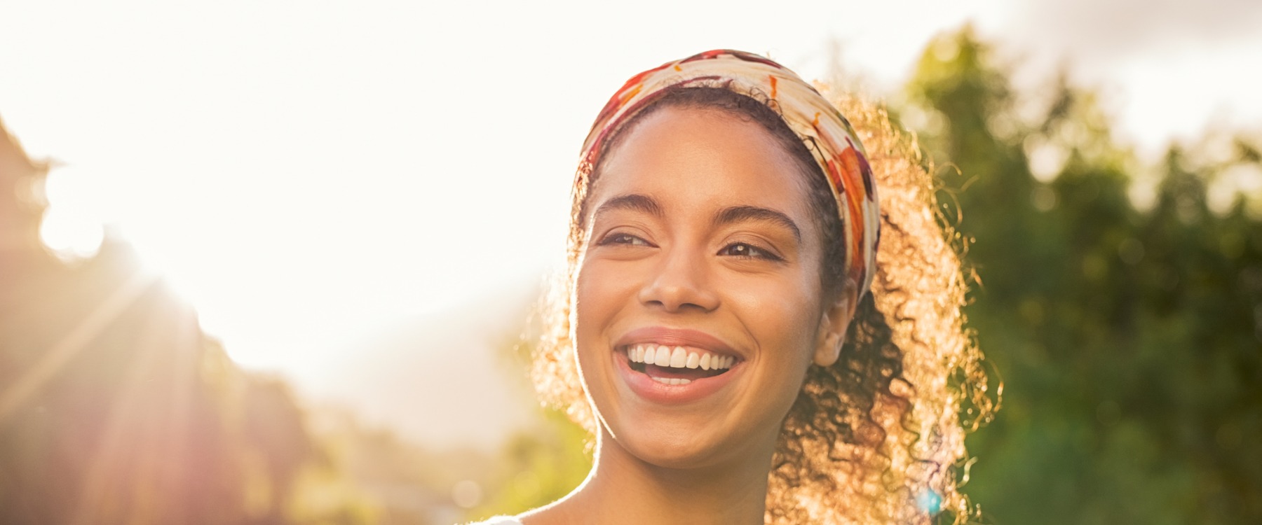 Young woman smiling at sunset