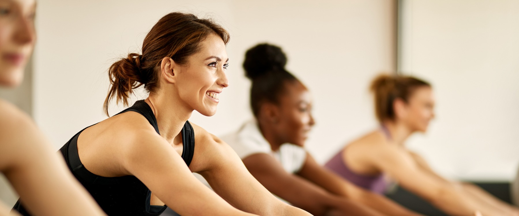 Young happy woman doing yoga class